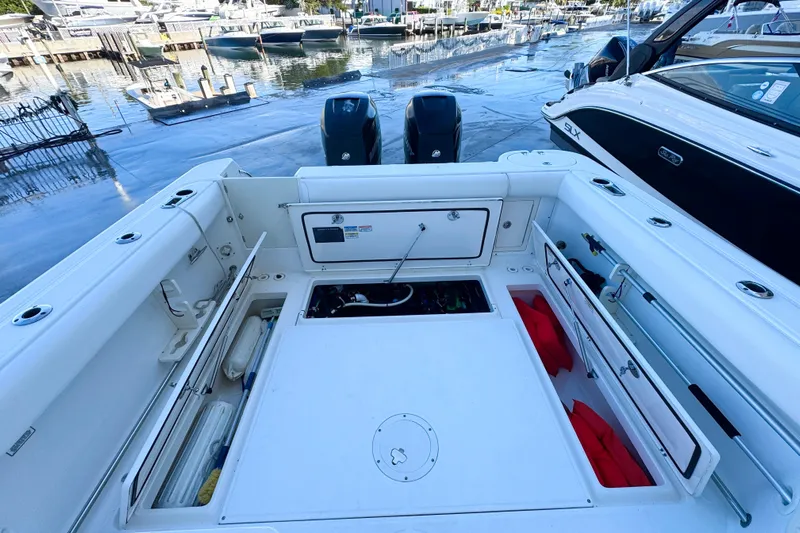 Turn Key Yacht Photos Pics 2006 Boston Whaler 285 Conquest boat interior with storage compartments and twin engines.