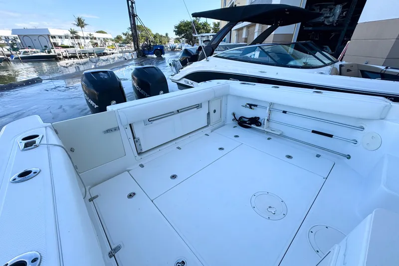 Turn Key Yacht Photos Pics 2006 Boston Whaler 285 Conquest boat deck with dual Mercury engines, docked at marina.