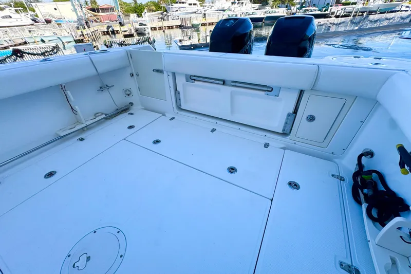 Turn Key Yacht Photos Pics 2006 Boston Whaler 285 Conquest boat deck with storage compartments and twin engines.