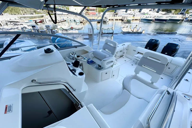 Turn Key Yacht Photos Pics 2006 Boston Whaler 285 Conquest boat interior with helm, seating, and dock view.