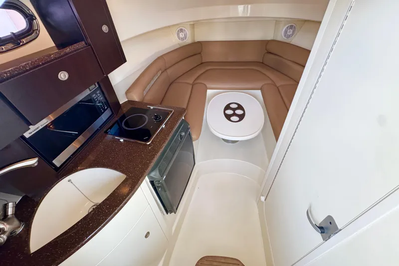 Turn Key Yacht Photos Pics 2006 Boston Whaler 285 Conquest cabin interior with kitchenette and seating area.