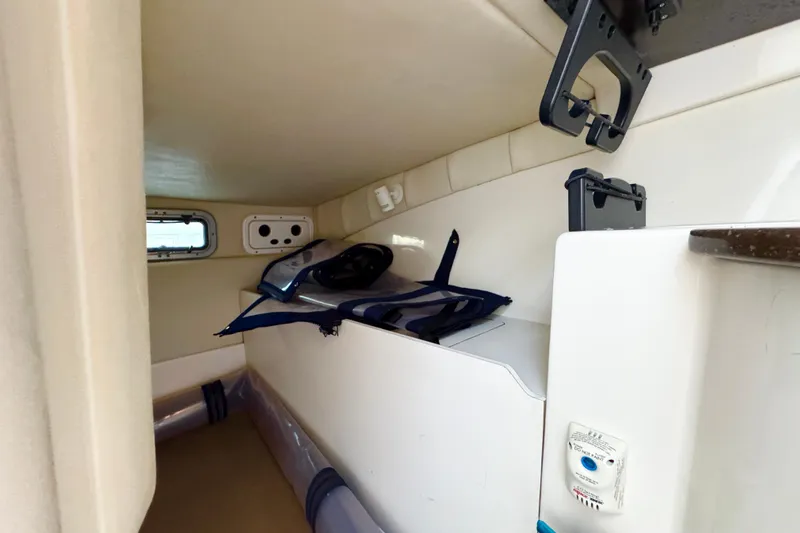 Turn Key Yacht Photos Pics 2006 Boston Whaler 285 Conquest cabin interior with storage and equipment.