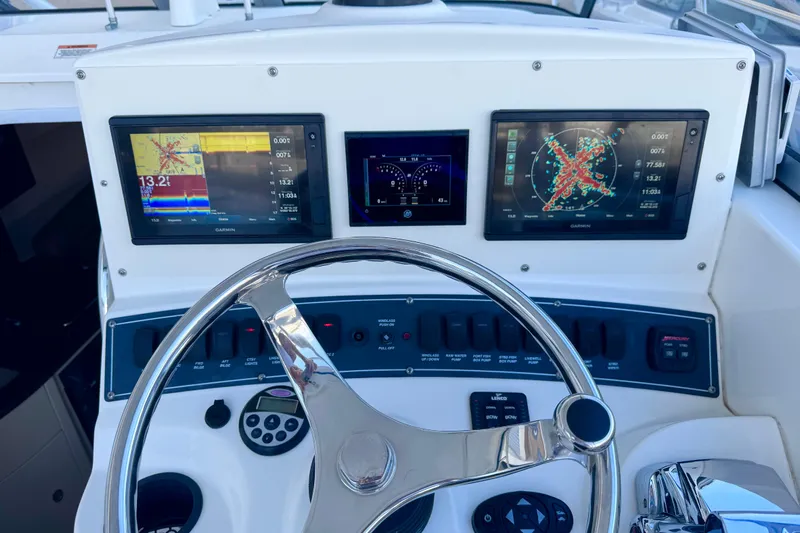 Turn Key Yacht Photos Pics Dashboard of a 2006 Boston Whaler 285 Conquest with navigation screens and controls.