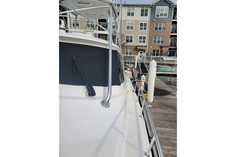 Salty Soul Yacht Photos Pics 2023 Viking 48 Sport Tower yacht docked at marina, side view.