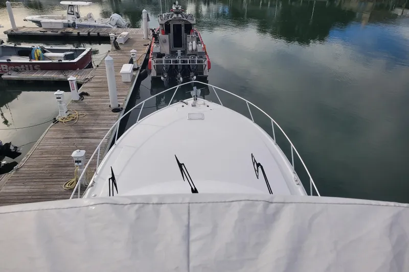 Salty Soul Yacht Photos Pics 2023 Viking 48 Sport Tower docked at marina, viewed from above.