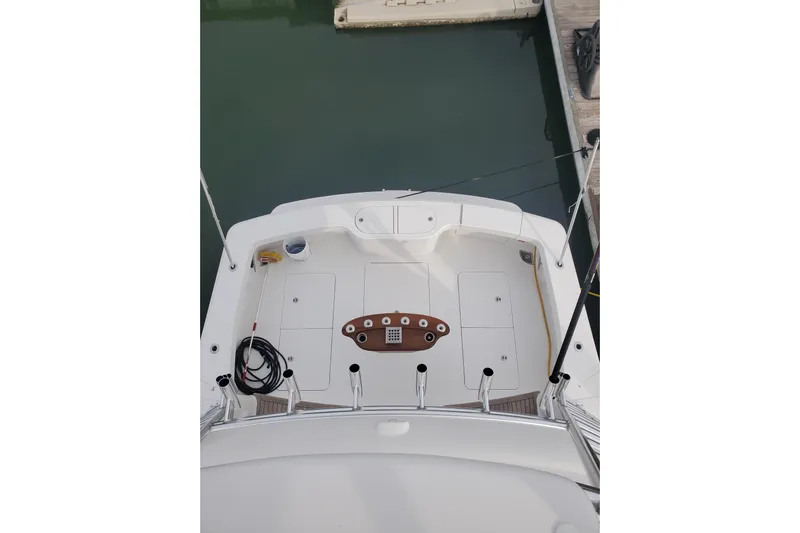 Salty Soul Yacht Photos Pics 2023 Viking 48 Sport Tower yacht deck, featuring fishing rods and clean white surface.
