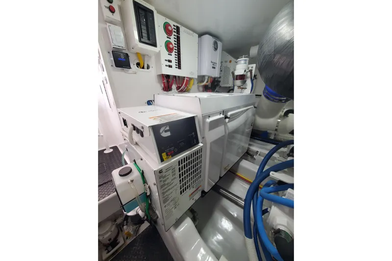 Salty Soul Yacht Photos Pics Engine room of 2023 Viking 48 Sport Tower with Cummins generator and control panels.