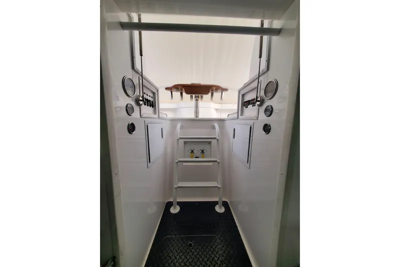 Salty Soul Yacht Photos Pics 2023 Viking 48 Sport Tower interior with control panel and ladder.