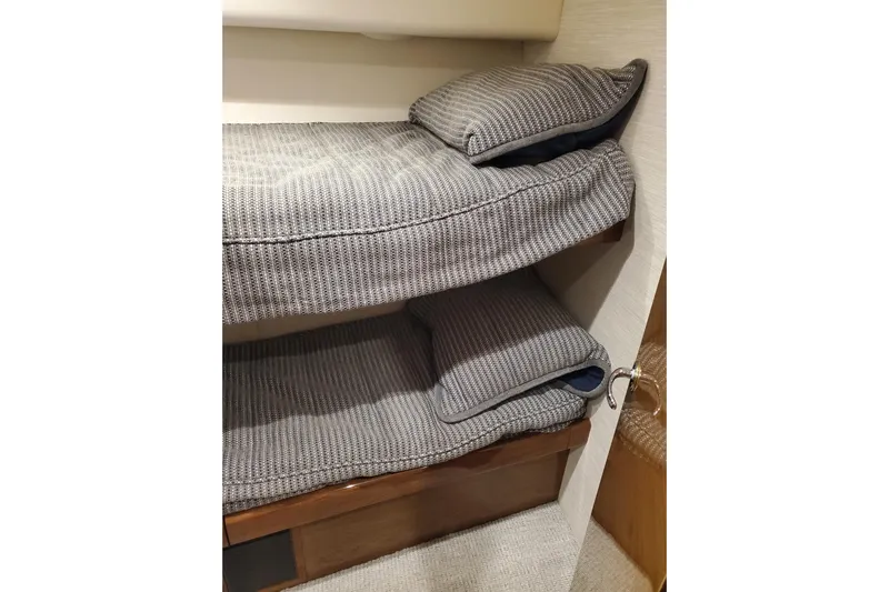 Salty Soul Yacht Photos Pics Bunk beds with gray cushions in 2023 Viking 48 Sport Tower yacht interior.