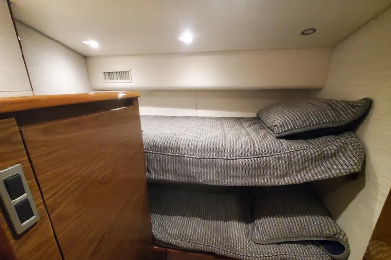 Salty Soul Yacht Photos Pics 2023 Viking 48 Sport Tower cabin with cozy bunk beds and modern lighting.