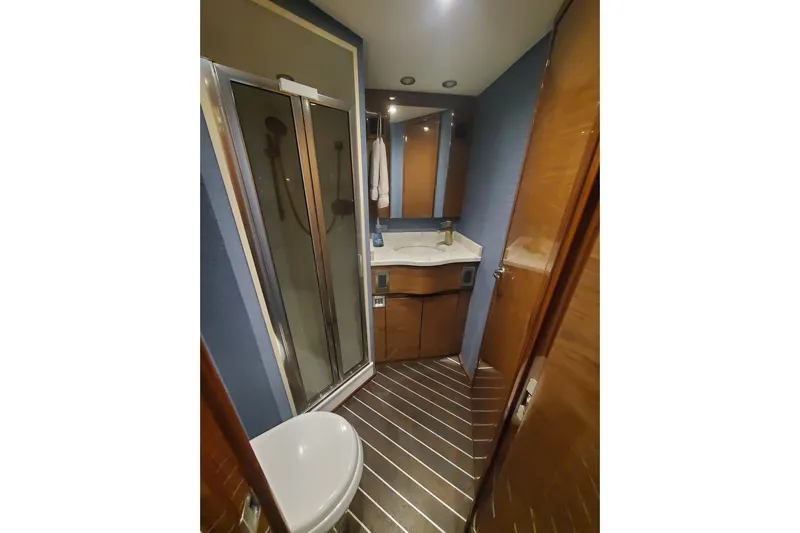 Salty Soul Yacht Photos Pics Luxurious bathroom in 2023 Viking 48 Sport Tower yacht with modern fixtures and wood accents.