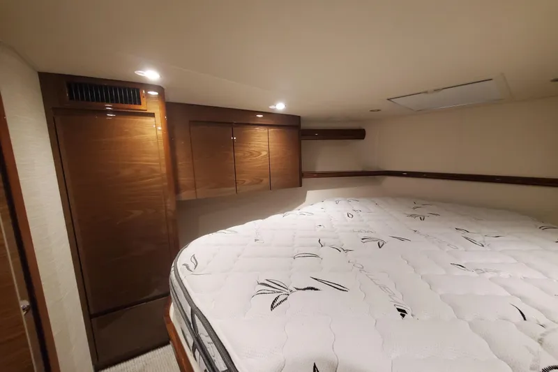 Salty Soul Yacht Photos Pics Luxurious cabin interior of 2023 Viking 48 Sport Tower yacht with plush bedding.