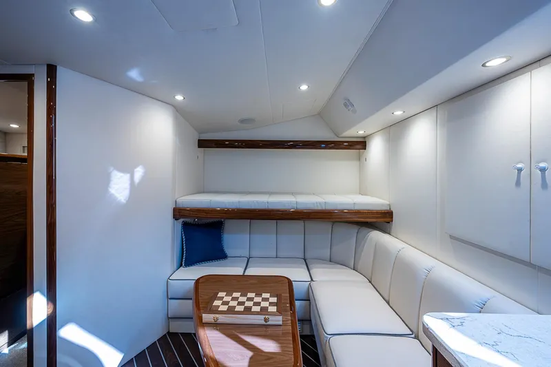 Salty Soul Yacht Photos Pics Luxurious interior of 2023 Viking 48 Sport Tower yacht with cozy seating and chessboard.