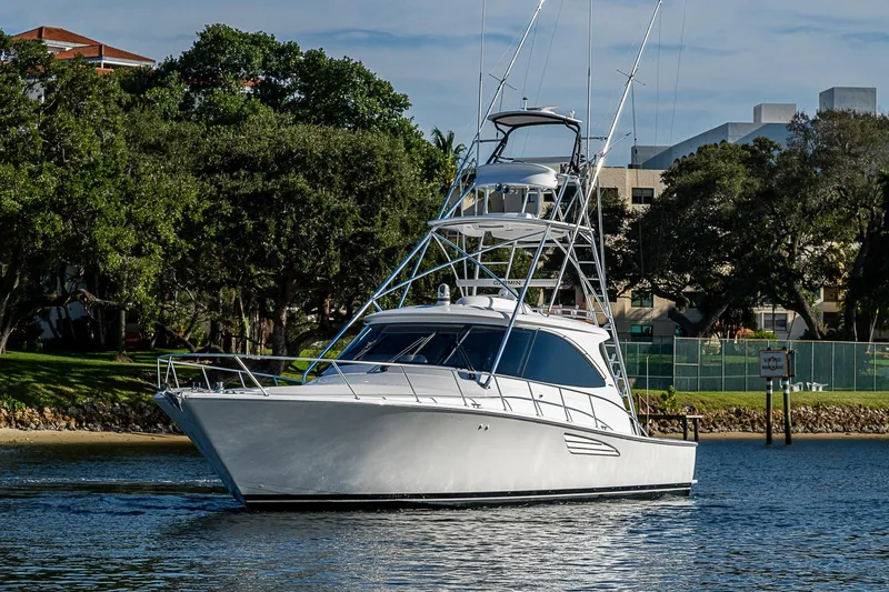 Salty Soul Yacht Photos Pics 2023 Viking 48 Sport Tower yacht cruising on a serene waterway.