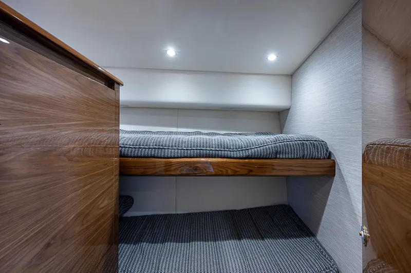 Salty Soul Yacht Photos Pics 2023 Viking 48 Sport Tower cabin with wooden bunk beds and modern lighting.