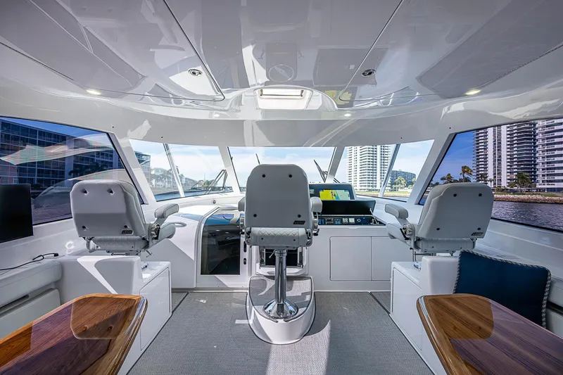 Salty Soul Yacht Photos Pics Interior of 2023 Viking 48 Sport Tower yacht with modern helm and seating.