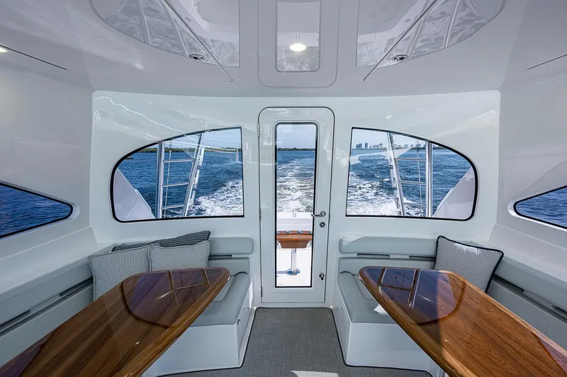 Salty Soul Yacht Photos Pics Interior of 2023 Viking 48 Sport Tower yacht with ocean view through windows.