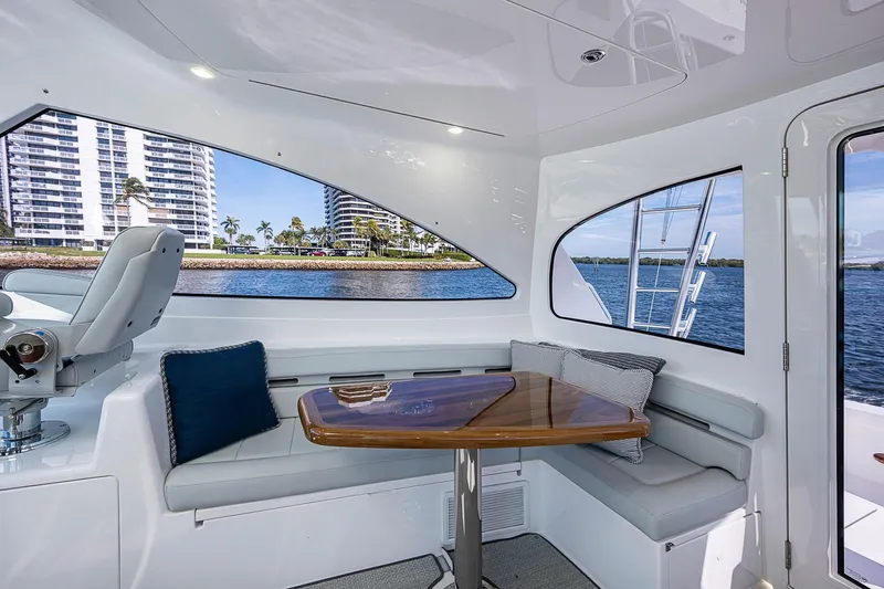 Salty Soul Yacht Photos Pics Interior of 2023 Viking 48 Sport Tower yacht with seating and waterfront view.