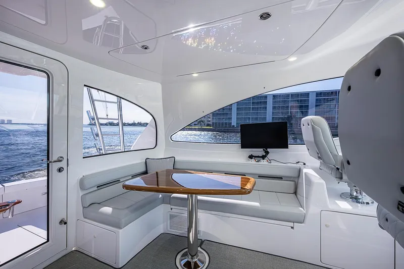 Salty Soul Yacht Photos Pics Luxurious interior of 2023 Viking 48 Sport Tower yacht with seating and ocean view.
