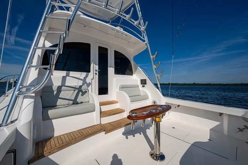 Salty Soul Yacht Photos Pics 2023 Viking 48 Sport Tower yacht deck with seating and ocean view.