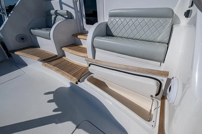 Salty Soul Yacht Photos Pics 2023 Viking 48 Sport Tower seating area with storage and wooden steps.