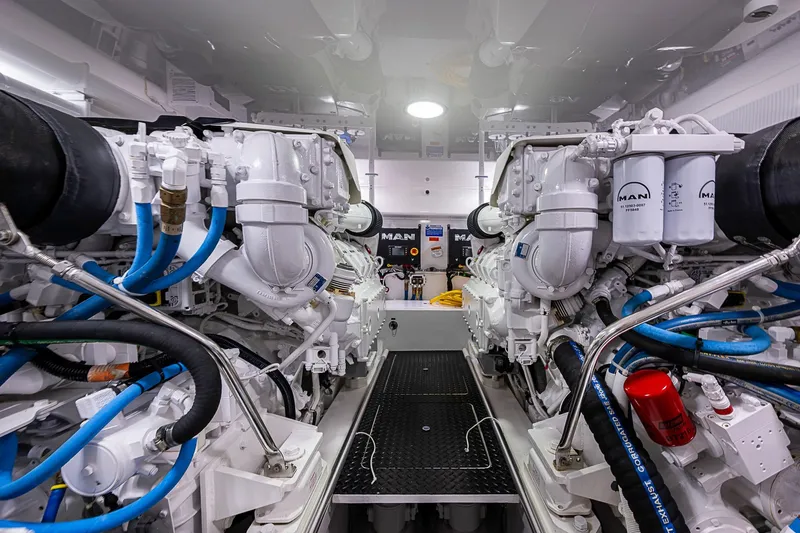 Salty Soul Yacht Photos Pics Engine room of 2023 Viking 48 Sport Tower with MAN engines and blue hoses.