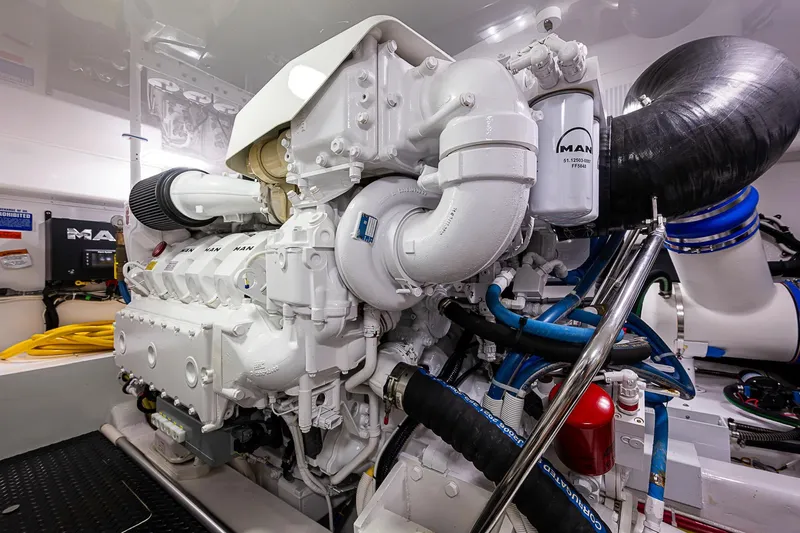 Salty Soul Yacht Photos Pics Engine room of 2023 Viking 48 Sport Tower with MAN engine components.