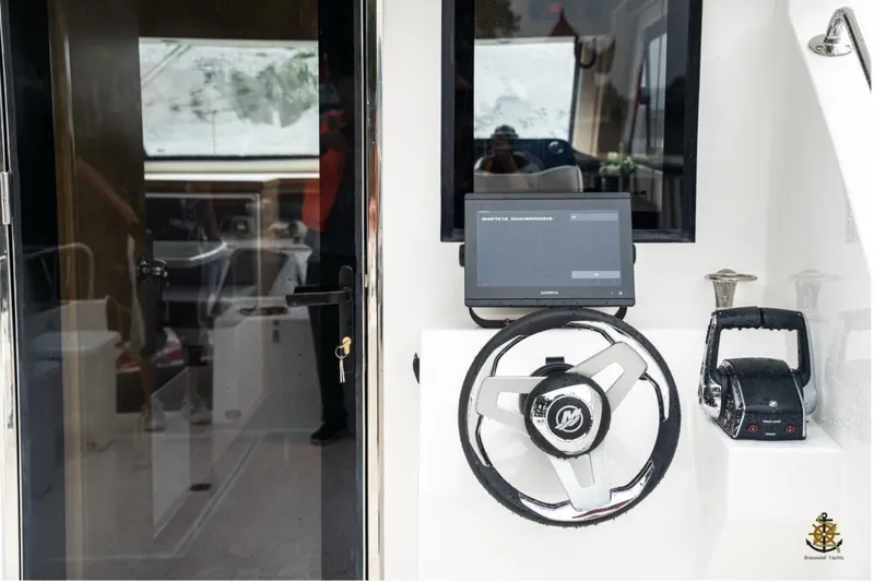 Commander Yacht Photos Pics 2024 Bracewell 36SF Commander helm with steering wheel and navigation display.