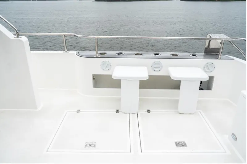 Commander Yacht Photos Pics 2024 Bracewell 36SF Commander boat deck with seating and railing, overlooking water.