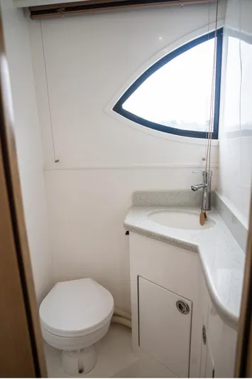 Commander Yacht Photos Pics 2024 Bracewell 36SF Commander yacht bathroom with modern fixtures and curved window.