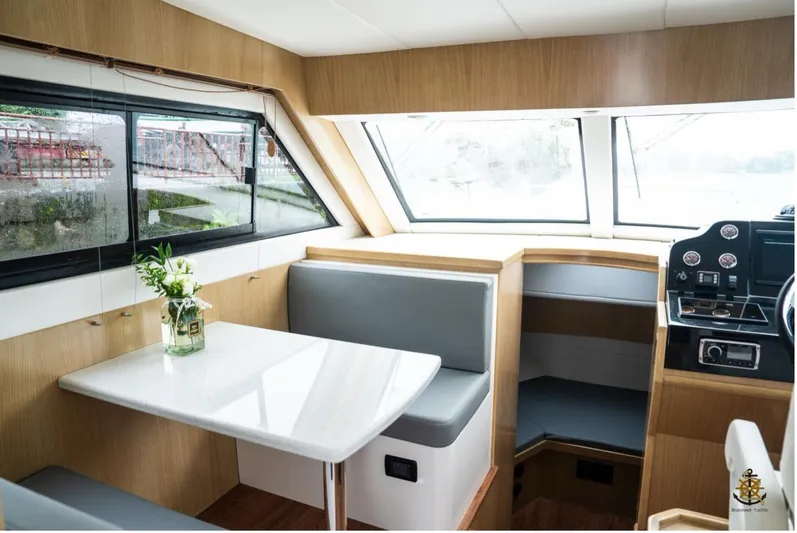 Commander Yacht Photos Pics Interior of 2024 Bracewell 36SF Commander yacht with dining area and helm.