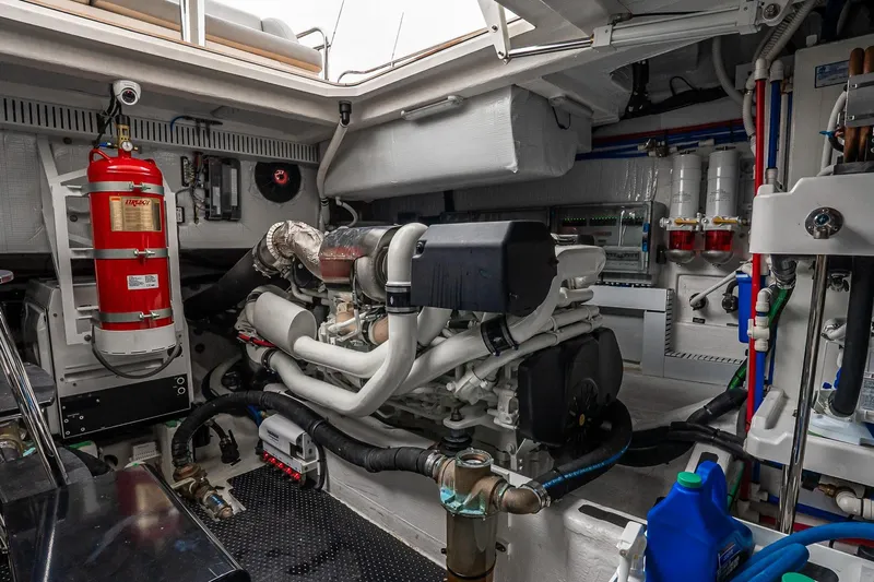  Yacht Photos Pics Engine room of 2024 Sabre 58 Salon Express with fire extinguisher and mechanical components.