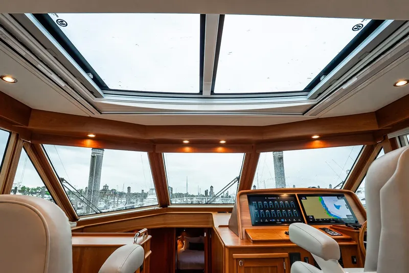  Yacht Photos Pics Luxurious interior of 2024 Sabre 58 Salon Express yacht with panoramic windows and advanced navigation system.