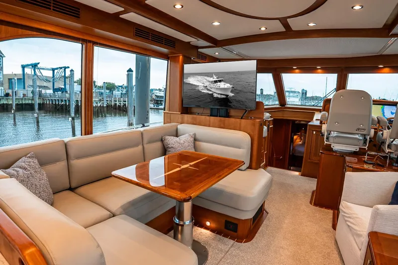  Yacht Photos Pics Luxurious interior of 2024 Sabre 58 Salon Express yacht with elegant seating and large windows.