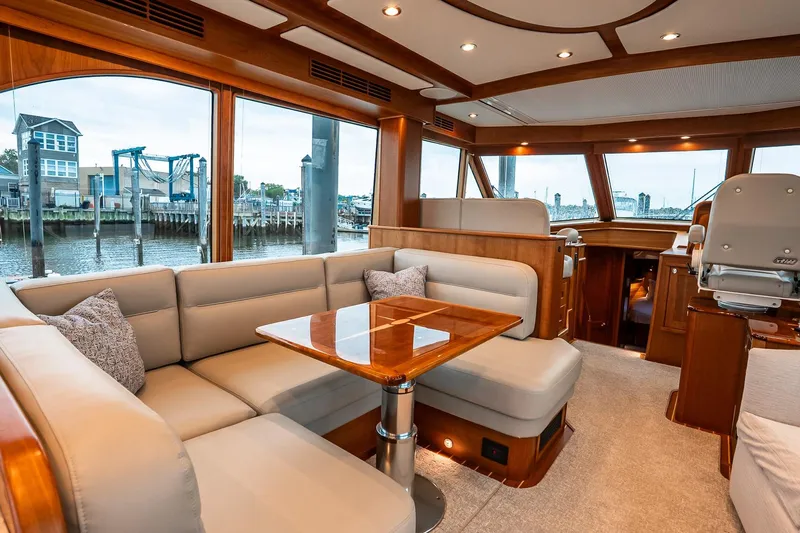  Yacht Photos Pics Luxurious interior of 2024 Sabre 58 Salon Express yacht with elegant seating and wooden accents.