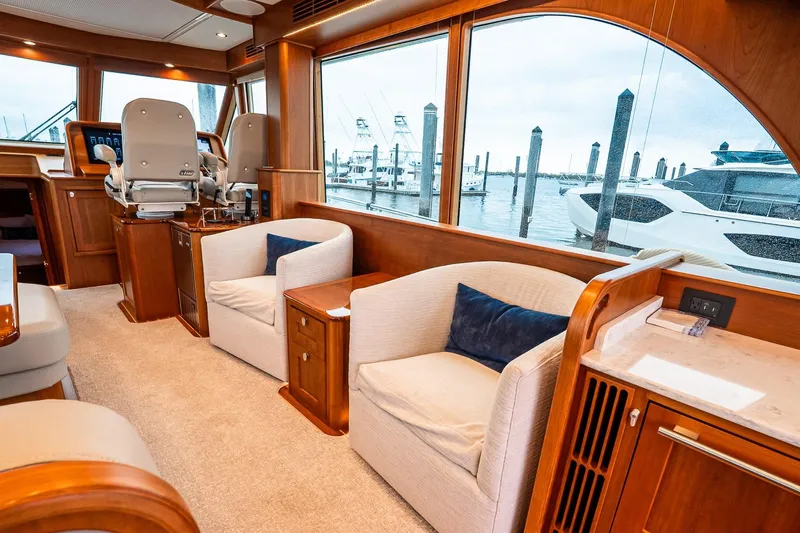  Yacht Photos Pics Luxurious interior of 2024 Sabre 58 Salon Express yacht with plush seating and large windows.