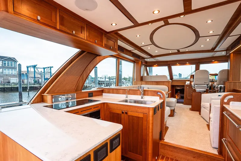  Yacht Photos Pics Luxurious interior of 2024 Sabre 58 Salon Express yacht with elegant wood finishes.