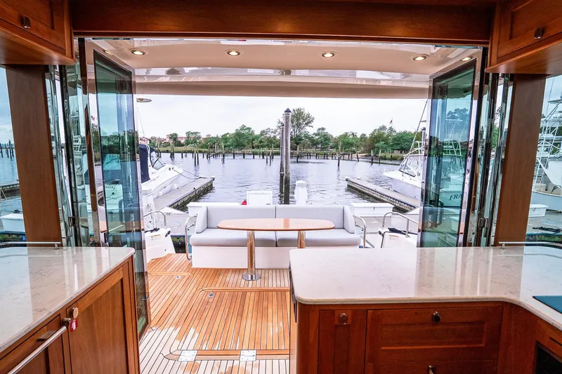  Yacht Photos Pics 2024 Sabre 58 Salon Express yacht interior with open deck view, featuring elegant wood finishes.