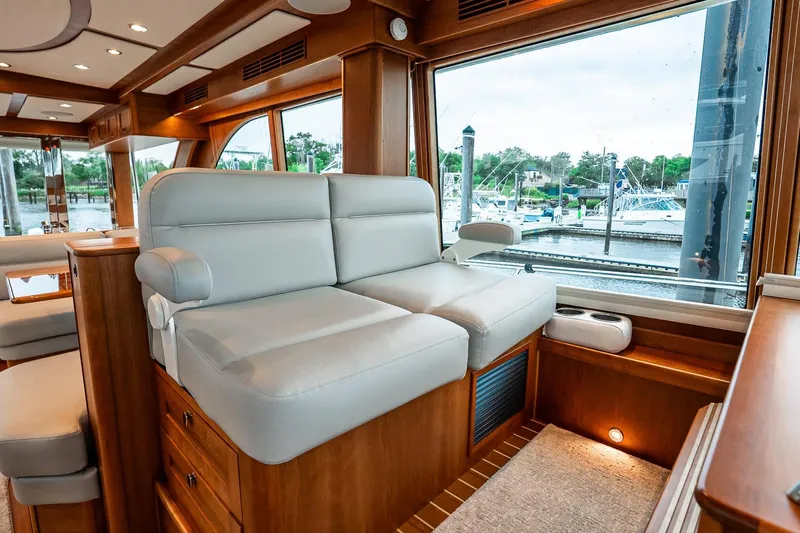  Yacht Photos Pics Luxurious interior of 2024 Sabre 58 Salon Express yacht with plush seating and marina view.
