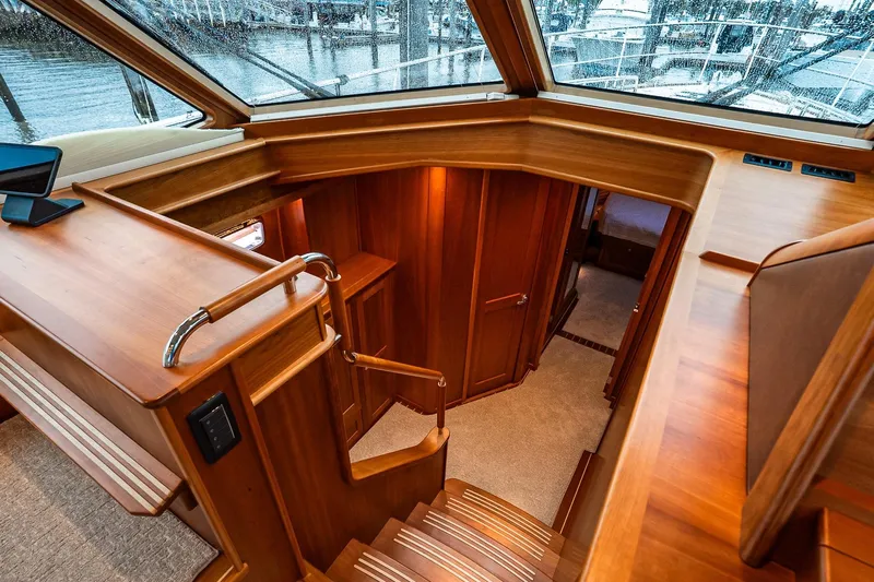  Yacht Photos Pics Luxurious interior of 2024 Sabre 58 Salon Express yacht with wooden finishes and staircase.