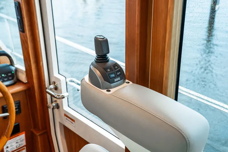  Yacht Photos Pics 2024 Sabre 58 Salon Express interior joystick control by window, showcasing luxury design.