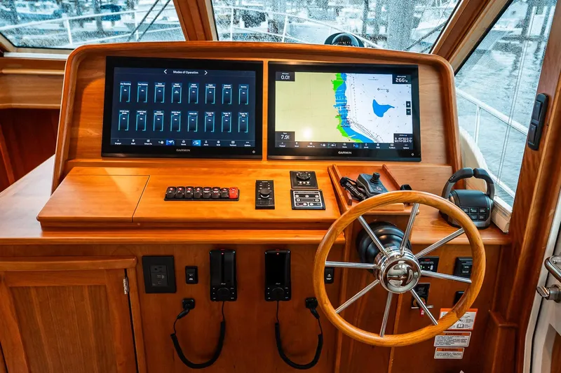  Yacht Photos Pics 2024 Sabre 58 Salon Express helm with dual screens and wooden steering wheel.