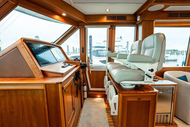  Yacht Photos Pics Luxurious interior of 2024 Sabre 58 Salon Express yacht with modern helm and seating.