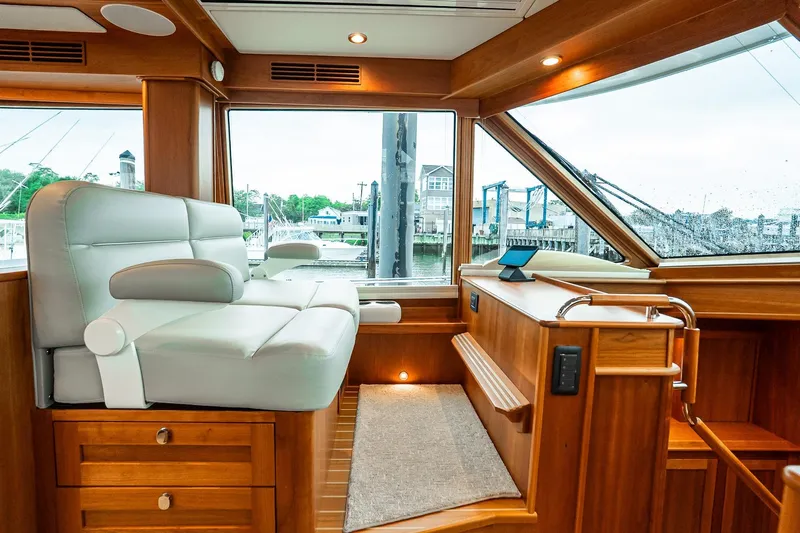  Yacht Photos Pics 2024 Sabre 58 Salon Express interior with luxurious seating and wooden finishes.