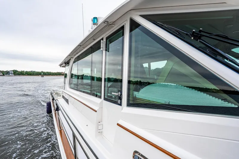  Yacht Photos Pics 2024 Sabre 58 Salon Express yacht cruising on open water, side view.