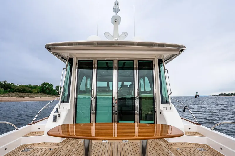  Yacht Photos Pics 2024 Sabre 58 Salon Express yacht with elegant deck and glass doors, on open water.