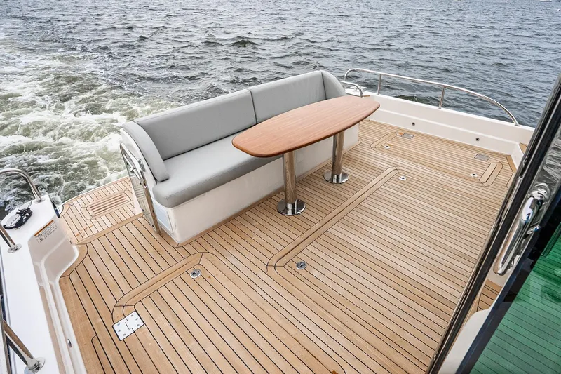  Yacht Photos Pics 2024 Sabre 58 Salon Express yacht deck with elegant seating and wooden flooring.
