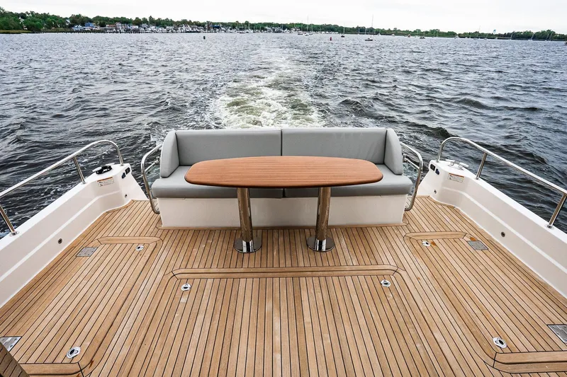  Yacht Photos Pics 2024 Sabre 58 Salon Express yacht deck with seating and table on open water.