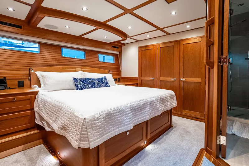  Yacht Photos Pics Luxurious 2024 Sabre 58 Salon Express yacht bedroom with elegant wood finish.