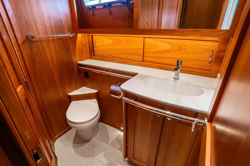  Yacht Photos Pics Luxurious bathroom in 2024 Sabre 58 Salon Express yacht with wooden cabinetry and modern fixtures.